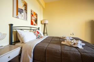 a bedroom with a bed and a table and a lamp at Kanali seaside apartment Poros 2 in Poros