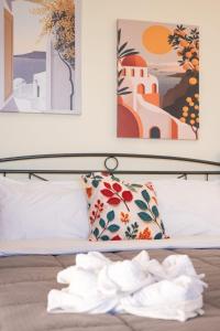 a hotel room with a bed with towels on the floor at Kanali seaside apartment Poros 2 in Poros