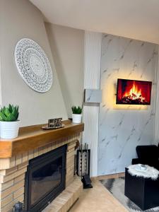 a living room with a fireplace with a fire place at A Casiña do Patio in Quiroga