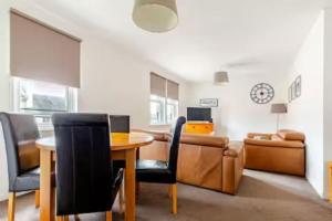 a living room with a table and a couch at Irvine Harbor Apartments in Irvine