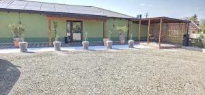 a building with potted plants in front of it at Motel Remo in Lovrin +6 photos