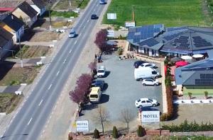 an aerial view of a parking lot next to a road at Motel Remo in Lovrin