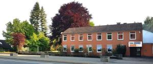 a large brick building on the side of a street at Pension Highway 3 - Bielefeld Paderborner Straße 290 in Bielefeld