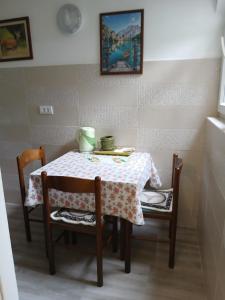 a table with two chairs and a table with a table cloth at Apartments Vučinović in Tivat