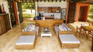 a patio with couches and a table and a kitchen at Hotel Acantilado de La Tierra by On vacation in San Andrés