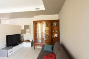 a living room with a couch and a television at Casa Vacanza Neris in Clusane sul Lago