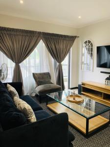 a living room with a couch and a coffee table at The Bridge at Montego in Fourways