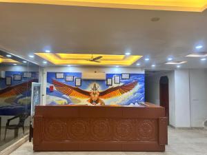a room with a large painting of an eagle on the wall at The great Garuda hotel in Rishīkesh