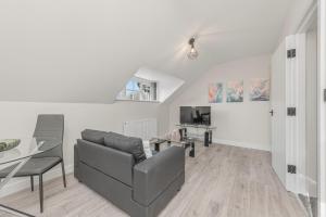 a living room with a couch and a table at Ascot Grange Hotel & Apartments in Leeds