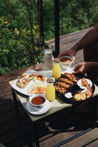 a table with a tray of breakfast food on it at The Boato Hotel in Guatapé