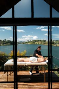 a man and a woman laying on a mattress at The Boato Hotel in Guatapé