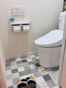 a bathroom with a toilet and some shoes on the floor at 旅の宿 もはち Private Guesthouse MOHACHI in Tsuruoka +24 photos