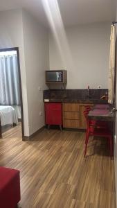 a living room with a table and a microwave at Pousada e Hotel Mirasol in Mato Verde