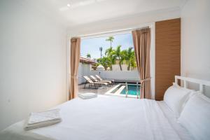 a bedroom with a bed and a view of a pool at Prima Villas Chalong Phuket in Chalong +260 photos