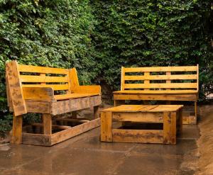 two wooden benches sitting next to each other at Inuka Guest house in Nairobi