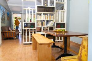 a living room with a table and a book shelf at Inuka Guest house in Nairobi