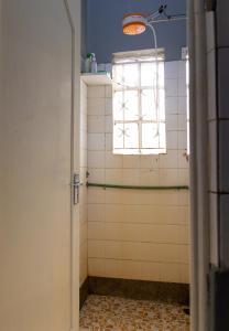 a bathroom with a shower with a window at Inuka Guest house in Nairobi +13 photos