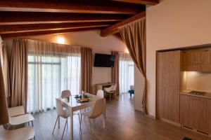 a living room with a white table and chairs at Club del Sole Desenzano Boutique Resort in Desenzano del Garda