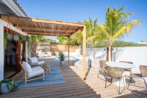 a wooden deck with chairs and a table at Villa CuraNova in Jan Thiel