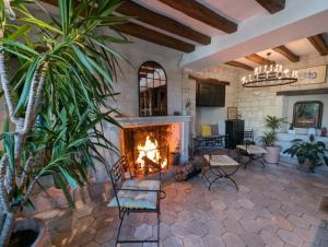 a living room with a fireplace in a house at Logis Hôtel Le Bussy in Montsoreau