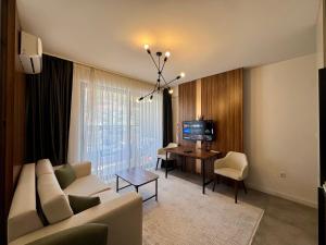 a living room with a couch and a table at Beachfront Rafailovici - Budva in Rafailovici