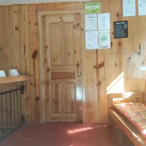 a room with a wooden door in a building at grandmas homestay in Sagada
