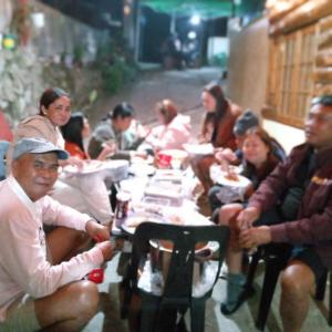 a group of people sitting at a table at grandmas homestay in Sagada
