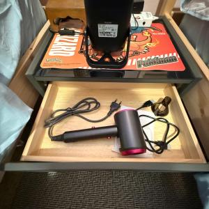 a box with a charger and a pen on a table at REHome in Bangkok