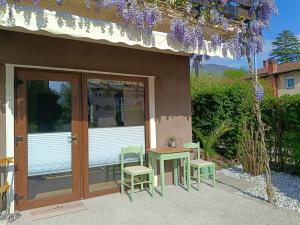 a patio with a table and chairs next to a building at Gravitacija East in Tolmin +4 photos