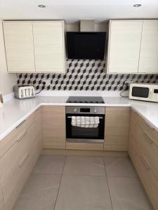a kitchen with a stove and a microwave at Binghambelle in Bangor +19 photos