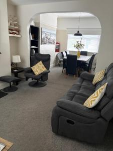 a living room with a couch and a dining room at Binghambelle in Bangor