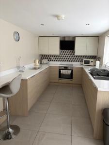 a kitchen with wooden cabinets and white counter tops at Binghambelle in Bangor
