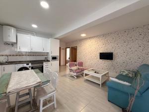 a kitchen and living room with a couch and a table at Apartamentos Cuberris in Ajo