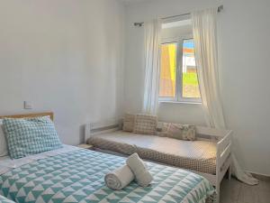 a bedroom with two beds and a window at Apartamentos Cuberris in Ajo