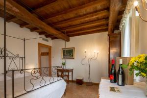 a bedroom with a bed and a table with wine bottles at Roccafiore Wine Resort & Spa in Todi +229 photos