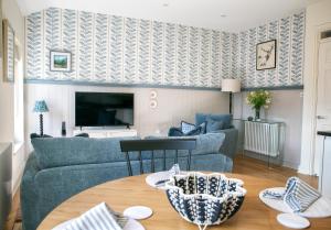 a living room with a couch and a table at The Green House deluxe 2 bedroom upper floor apartments in Harrogate