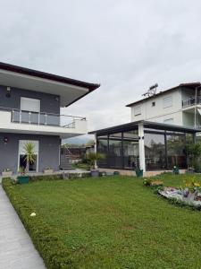 a large house with a lawn in front of it at Dragoti in Leptokarya