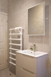 a bathroom with a sink and a towel rack at The Green House deluxe 2 bedroom upper floor apartments in Harrogate