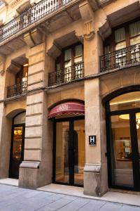a building with windows and doors on a street at Hotel Condal in Barcelona