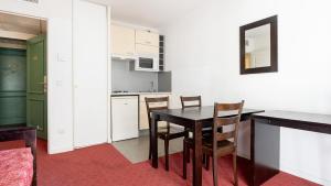 a kitchen and dining room with a table and chairs at Virginia N309 2P4 in Grasse +4 photos