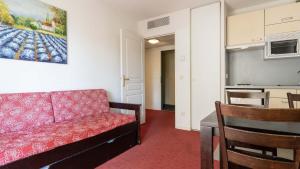 a living room with a couch and a table at Virginia N309 2P4 in Grasse