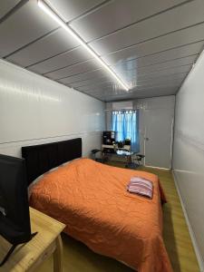 a bedroom with a bed and a desk with a computer at Amanecer Rio Limay 2 in Plottier