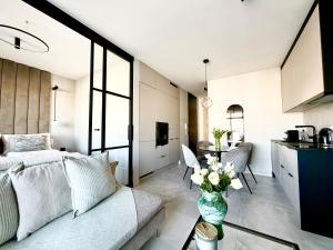a living room with a couch and a table at Apartamant Oaza II in Koszalin +1 photo