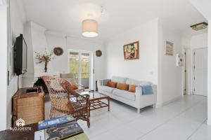a living room with a couch and a chair at BC Beach House - Santa Cruz in Santa Cruz