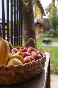 a basket of apples and pears on a bench at Casa Teiú in São Sebastião +23 photos