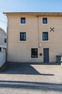 a large brick building with two windows and a door at Le Gerbolle in Reventin-Vaugris