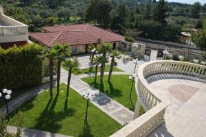 an aerial view of a park with palm trees and a building at Hotiday Corato in Corato