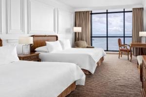 a hotel room with two beds and a large window at Intercontinental Miramar Panama by IHG in Panama City