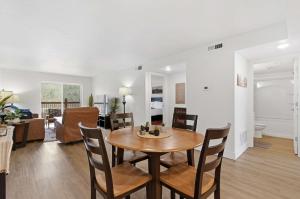 a dining room and living room with a table and chairs at Serene Creek Condo Pool & Gym in Branson