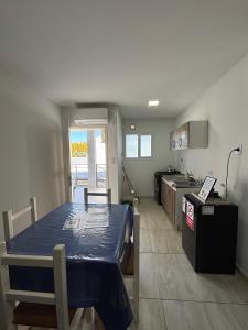 a room with a kitchen with a table in it at Amanecer Rio Limay in Plottier